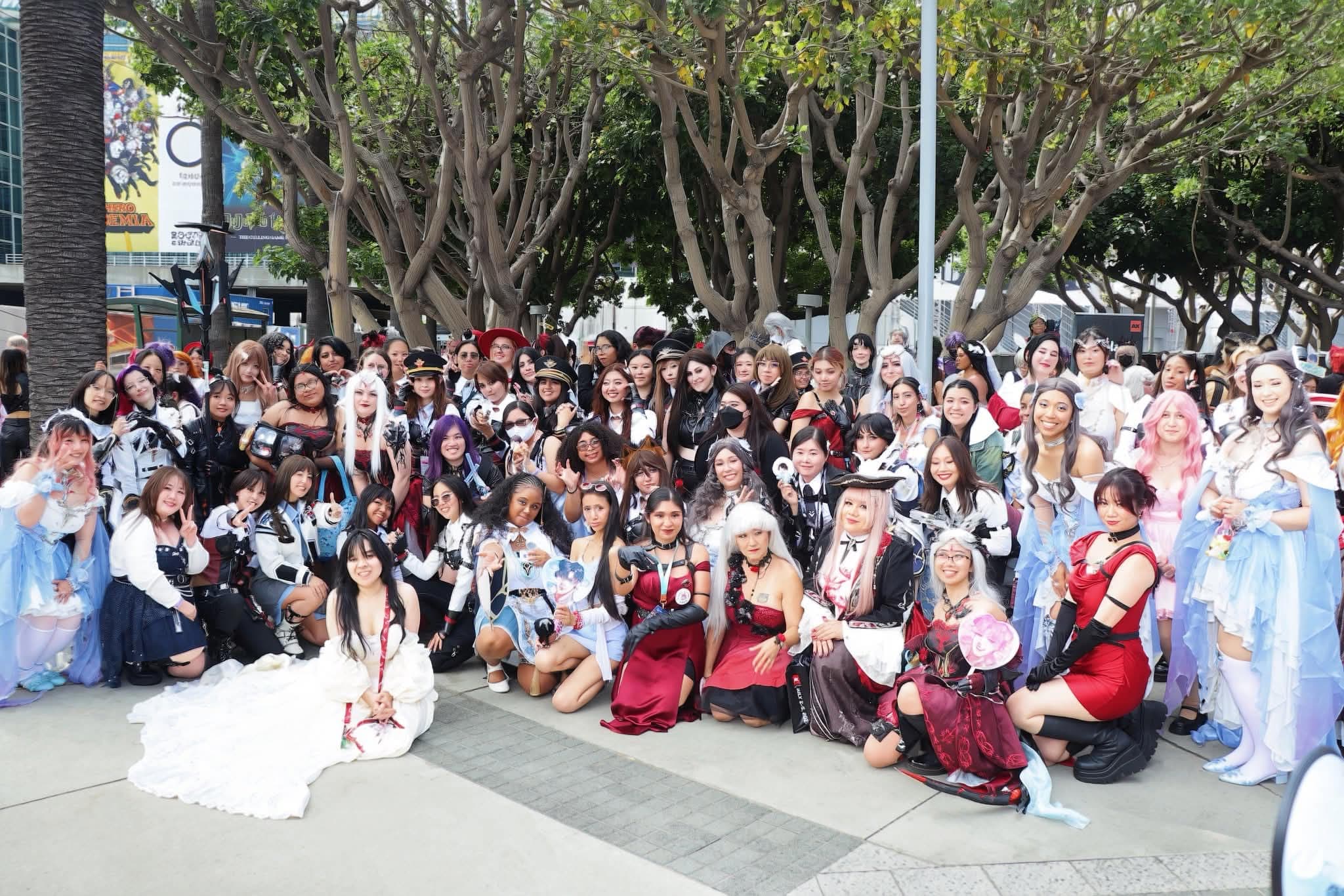 Amy in cosplay with a large group of fellow Love and Deepspace cosplayers at a convention